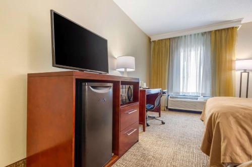 a hotel room with a television on top of a dresser at Quality Inn & Suites Olde Town in Portsmouth