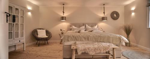 a bedroom with a bed and a chair and a table at Loft 1540 - Boutique Ferienwohnungen in Fulda