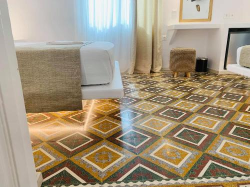 a room with a floor with a patterned floor at Semiramis Guesthouse in Adamas