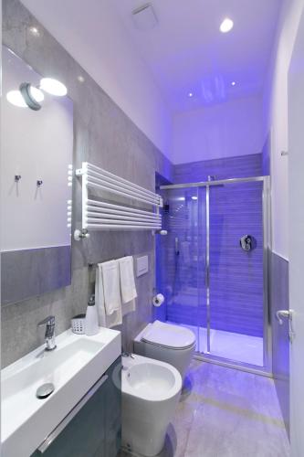a bathroom with a toilet and a sink and a shower at Marconi Dreams in Bologna