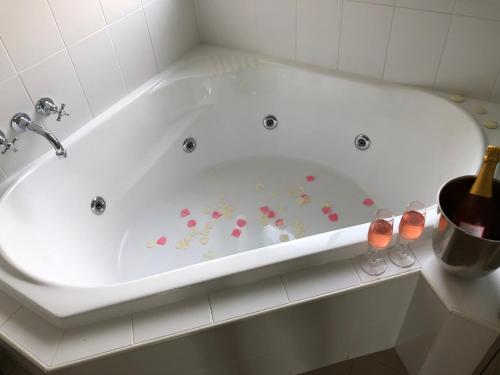 a white bath tub with flowers painted on it at Nightingale Villas in Broke