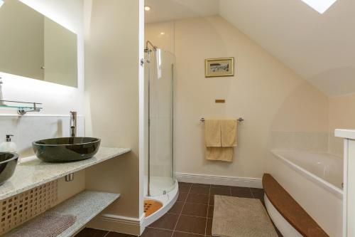 a bathroom with a shower and a sink and a toilet at Dún Ard in Dungarvan