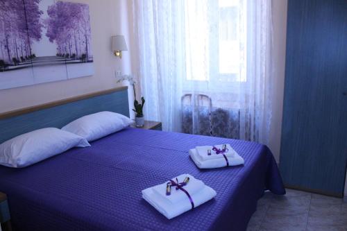 Letto o letti in una camera di Hotel Castelfidardo