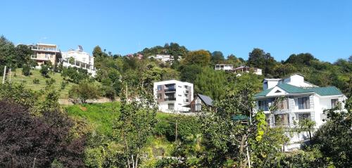a group of houses on a hill with trees at Boutique Hotel Sleep and Wine in Batumi