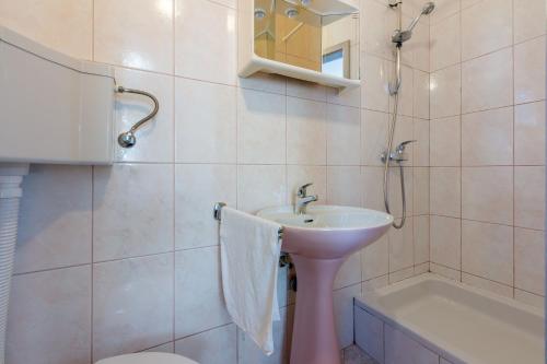 a bathroom with a sink and a toilet and a tub at Apartments Arijana in Dramalj
