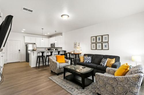 a living room with a couch and chairs and a kitchen at Gabrielle Townhomes in Boise