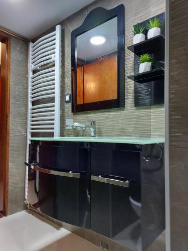 a bathroom with a sink and a mirror at Apartment Sunce in Sremska Mitrovica