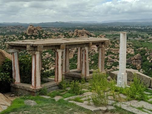 a monument on top of a hill with a obelisk at Hotel Varsha Hampi in Hampi