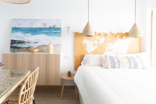 um quarto com uma cama branca e uma mesa em Coconut Beach Boutique Studio em Platja d'Aro