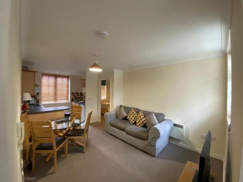 a living room with a couch and a table at Little Church Street in Rugby