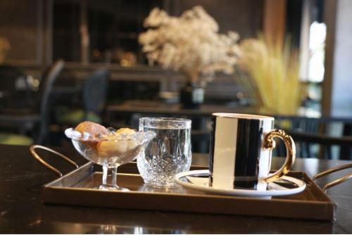 a tray with a coffee mug and a bowl of food at Air Boss Giresun City Hotel in Giresun