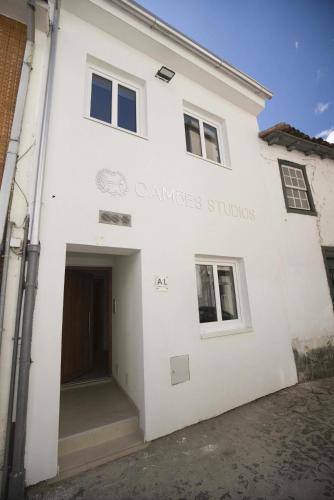 a white building with the entrance to thensics building at Camoes StudioGeral in Bragança