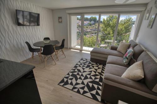 a living room with a couch and a table at Camoes StudioGeral in Bragança