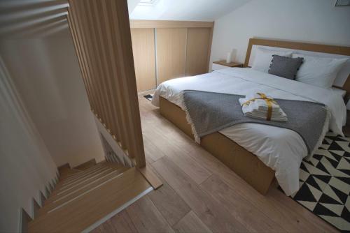 a bedroom with a bed with a bow on it at Camoes StudioGeral in Bragança