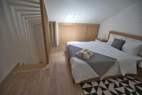 a bedroom with a large bed with a towel on it at Camoes StudioGeral in Bragança