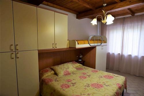 a bedroom with a bed and a cupboard and a bed sidx sidx at CASA MAIRA IN CENTRO A SATURNIA in Saturnia