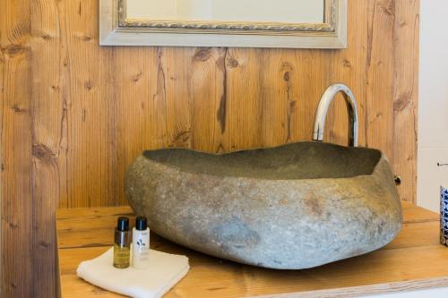 a stone bath tub sitting on a counter in a bathroom at Palais Gutenberg l´atelier in Klagenfurt