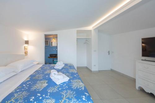 a bedroom with a bed with towels on it at Villa Costanza Amalfi Coast in Maiori