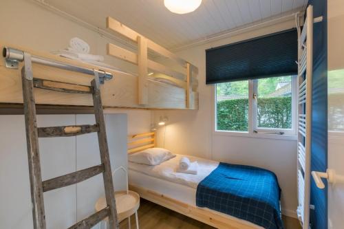 a bedroom with bunk beds and a ladder at Holidayhouse - Noordendolfer 2-49 Zoutelande in Zoutelande