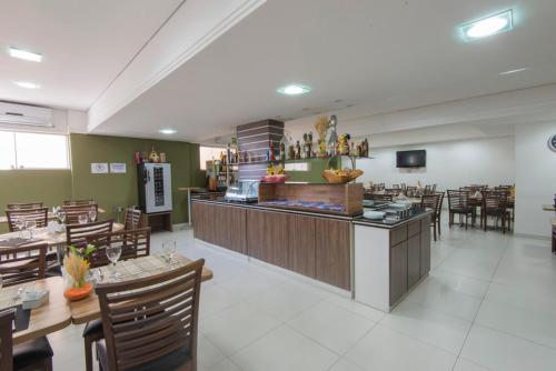 a restaurant with a bar and some tables and chairs at Monte Serrat Hotel in Santos
