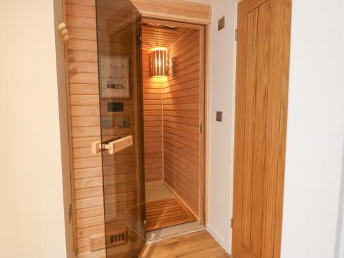 a walk in shower with a glass door at Fig Cottage in Kirkby Stephen