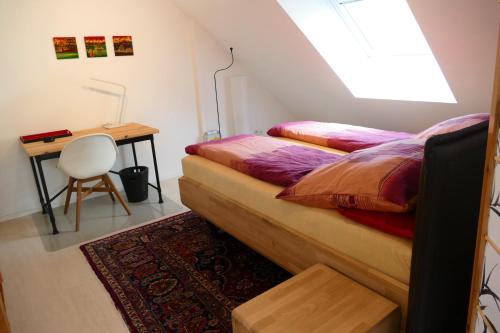 a bedroom with a desk and a bed and a table at Otterhaus in Trippstadt