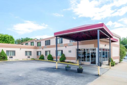 a front view of a building with a parking lot at Inn On Arsenal in Watertown