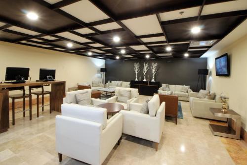 a living room with white couches and a table at Holiday Inn Monterrey Valle by IHG in Monterrey