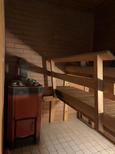 a room with a wooden stairs and a table at Kangru Holiday Home in Vanamõisa