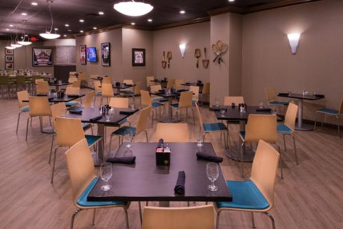 a dining room with tables and chairs and tablesktop at The Arch Convention Hotel in Saint Louis