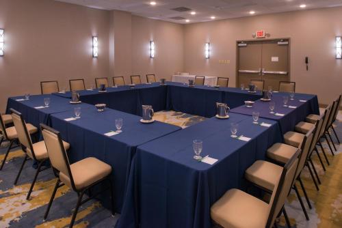 a conference room with blue tables and chairs at The Arch Convention Hotel in Saint Louis