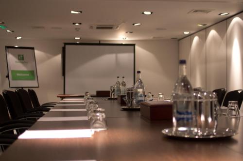a conference room with a long table with bottles on it at Holiday Inn Newcastle-Jesmond by IHG in Newcastle upon Tyne