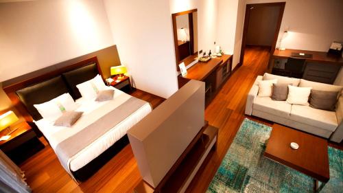 a large room with a bed and a couch at Sundance Hotel Istanbul in Istanbul