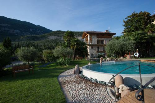 a house with a swimming pool in a yard at Da Gianni e Villa Annamaria in Arco