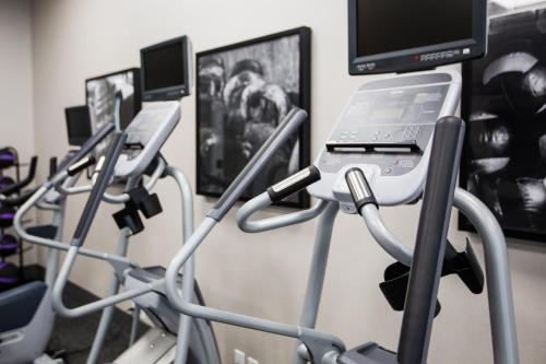 a row of exercise bikes in a gym at Holiday Inn Hotel & Suites Calgary South - Conference Ctr by IHG in Calgary