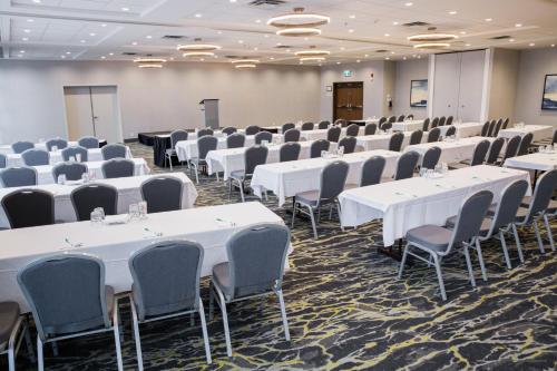 a room with rows of tables and chairs at Holiday Inn Hotel & Suites Calgary South - Conference Ctr by IHG in Calgary