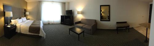 a hotel room with a bed and a chair at Holiday Inn Mexico Santa Fe by IHG in Mexico City