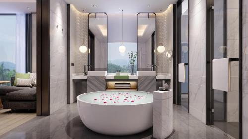 a bathroom with a tub with flowers on the floor at Holiday Inn Guangzhou South Lake, an IHG Hotel-Free shuttle bus to Canton Fair Complex during Canton Fair Period in Guangzhou