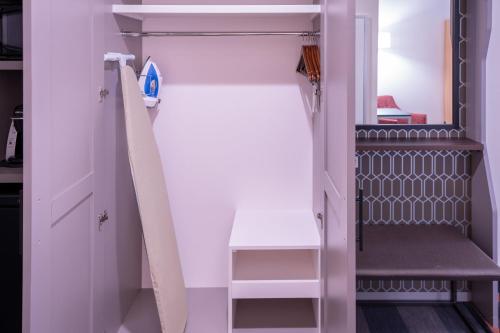 a room with a closet with a ladder and a shelf at Holiday Inn - NW Houston Beltway 8 by IHG in Houston