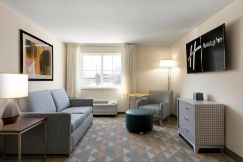 a living room with a couch and a chair at Holiday Inn - Bloomington W MSP Airport Area by IHG in Bloomington