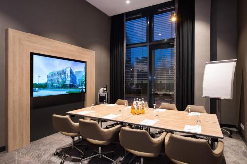 a conference room with a large table and a large window at Holiday Inn Frankfurt Airport by IHG in Frankfurt/Main