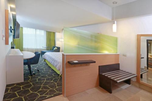 a hotel room with a bed and a desk at Holiday Inn Queretaro Zona Krystal by IHG in Querétaro