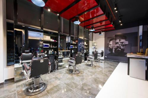 a barber shop with a bunch of barber chairs at Holiday Inn Muscat AlSeeb by IHG in Muscat