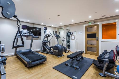 a gym with several treadmills and exercise bikes at Holiday Inn Sittingbourne by IHG in Sittingbourne