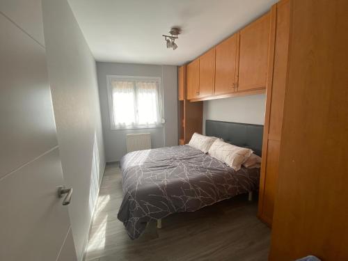 a small bedroom with a bed and a window at Apartamento Marbore (Torla-Ordesa) in Torla