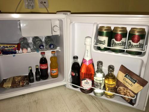 an open refrigerator filled with lots of bottles of alcohol at Tó- Party Panoráma Panzió & Wellness in Kiszombor