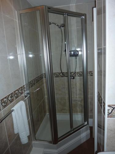 a shower with a glass door in a bathroom at Lavinia House in Whitby