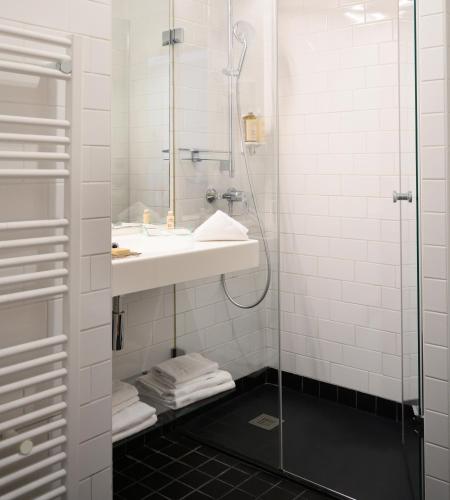 a bathroom with a sink and a shower at Hôtel Helzear Etoile in Paris