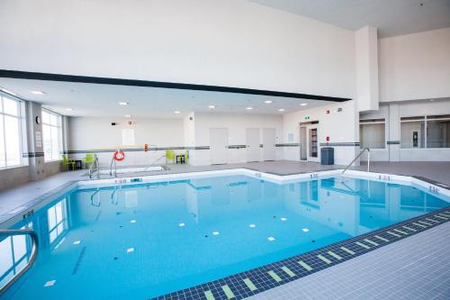 a large pool with blue water in a building at Holiday Inn Hotel & Suites Calgary South - Conference Ctr by IHG in Calgary