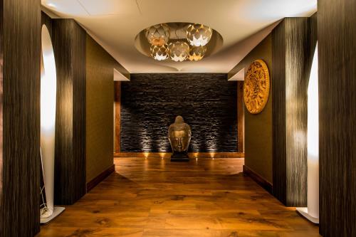 a hallway with a statue of a head on the wall at Holiday Inn London Kensington High St. by IHG in London